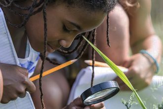 children looking through magnifying glass