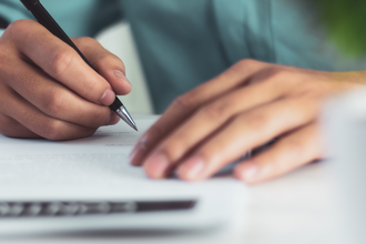 A person writing a letter 