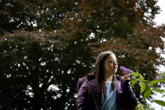 Person smelling flowers at Walthamstow Wetlands