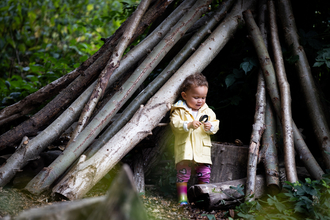 Child at Walthamstow Wetlands in a den