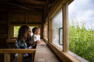 Woman and child in the bird hide at Walthamstow Wetlands