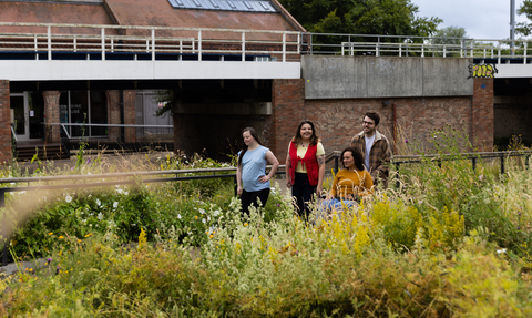 Group of four people walking away from Walthamstow Wetlands