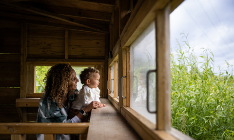Woman and child in the bird hide at Walthamstow Wetlands