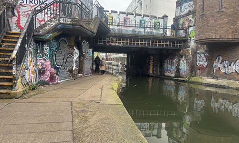 A graffiti covered bridge over a canal