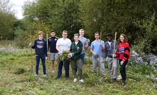 Volunteers standing in a line at Yeading Brook Meadows