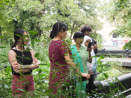 Youth board members amongst the green by the water at camley street natural park.