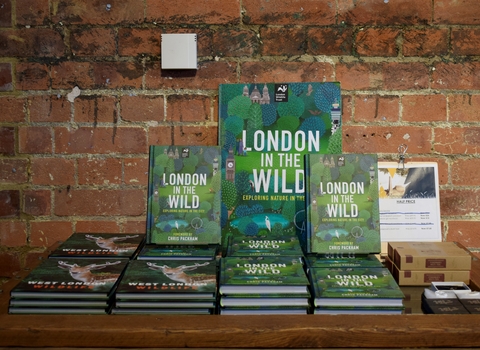 a collection of London in the wild books with a green front cover filled with illustrated leaves and text the reads london in the wild