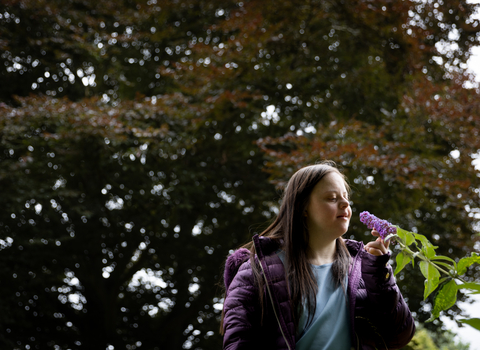 Person smelling flowers at Walthamstow Wetlands