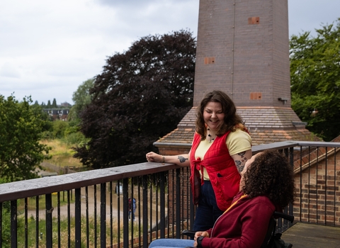 Two people looking out at Walthamstow Wetlands, cropped