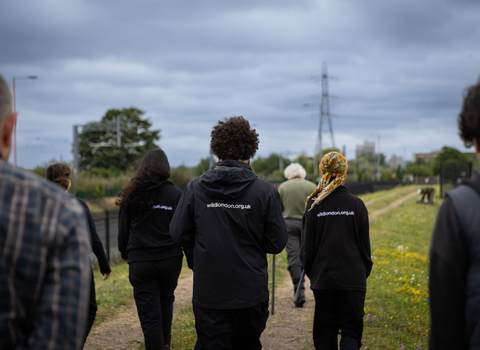 Staff walking away from camera at Walthamstow Wetlands