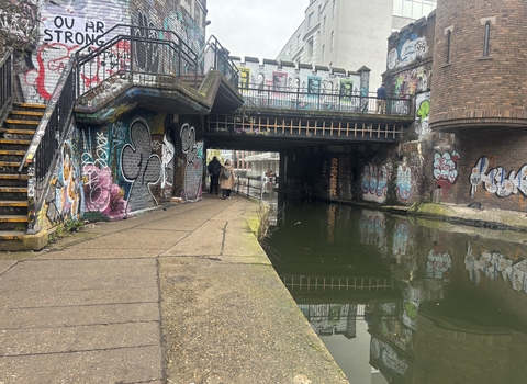 A graffiti covered bridge over a canal